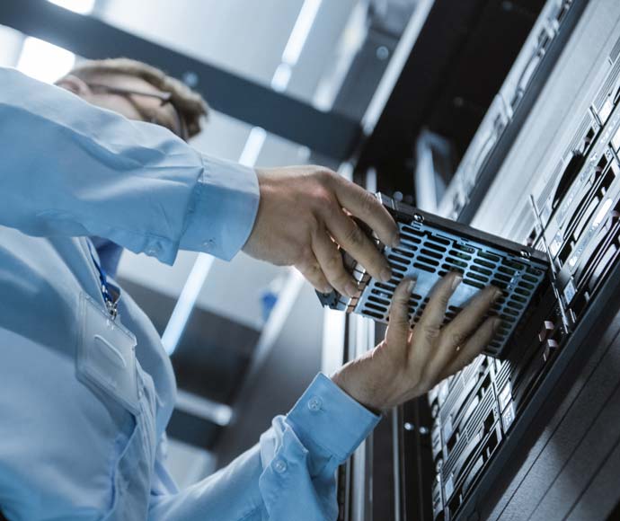 Man installing hard drive to rack