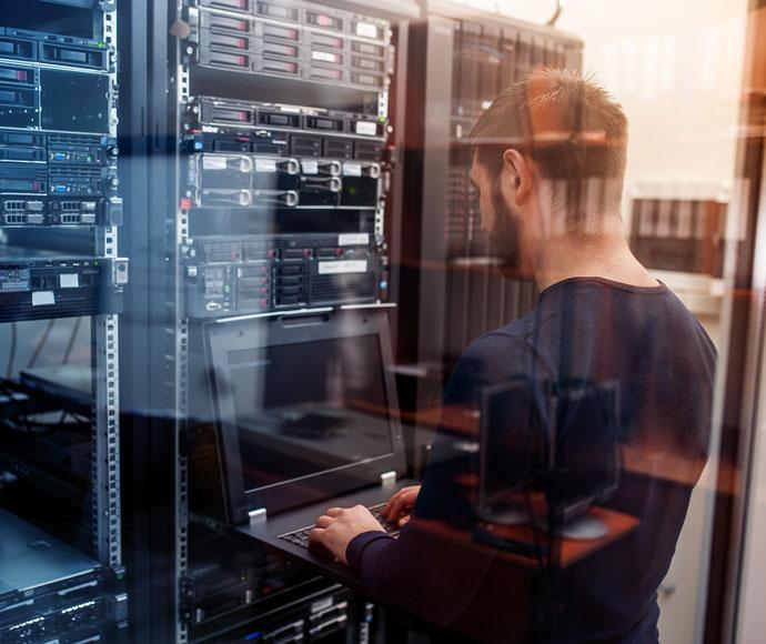 Man on keyboard near server